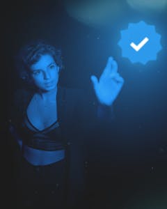 A woman engages with a digital interface, illuminated by a futuristic blue glow, symbolizing innovation.