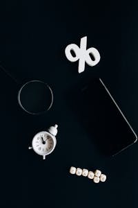 Stylish composition of clock, symbols, and text representing financial change on a dark background.